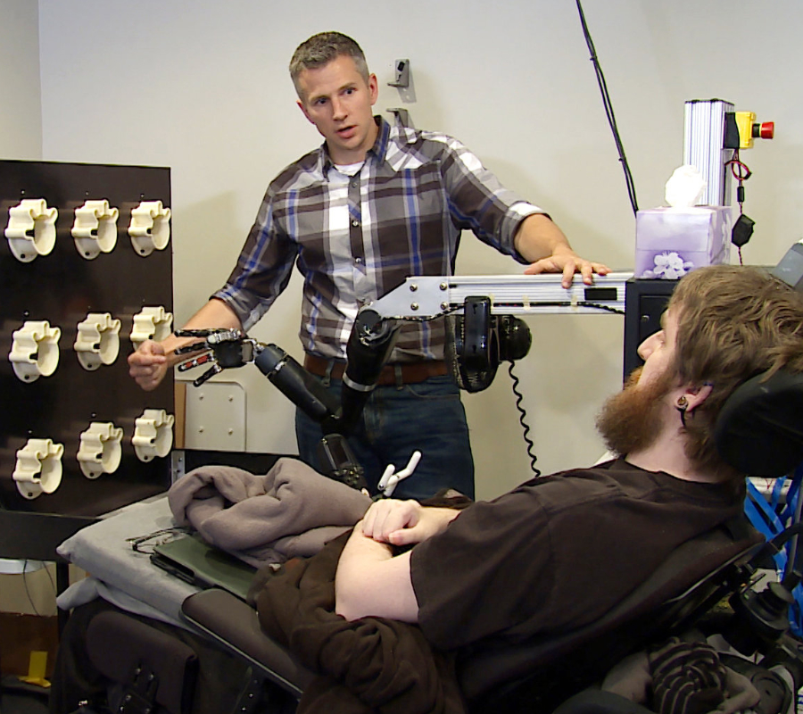 Brain implant makes paralyzed man feel a robotic arm