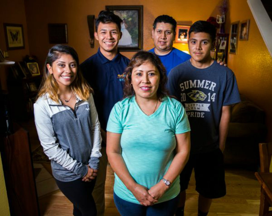 Imelda Vaquera-Torres (center), breast cancer survivor, stands with her family. Photo credit: Ashley Landis, Staff Photographer / Dallas News