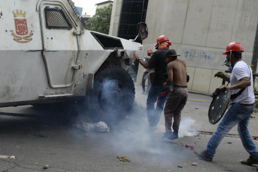 On Wednesday, during a clash between the National Guard and opposition masked protesters in Altamira, a neighborhood in Caracas, an armored tank ran over one of the protesters. Image credit:  Federico Parra / Getty Images / Univision