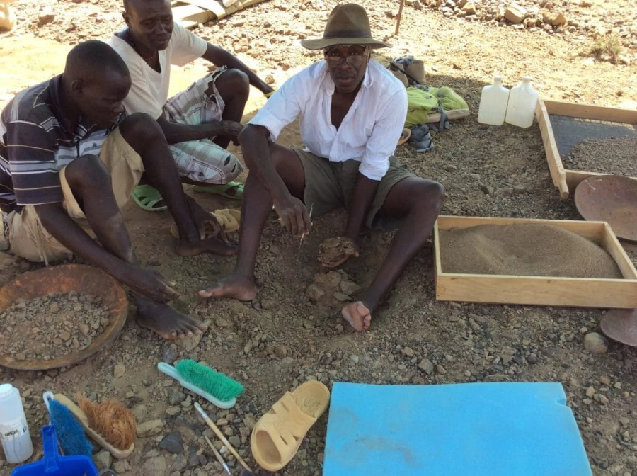 Akai Ekes and John Ekusi watch as Isaiah Nengo holds the skull. Image Credit: Isaiah Nengo