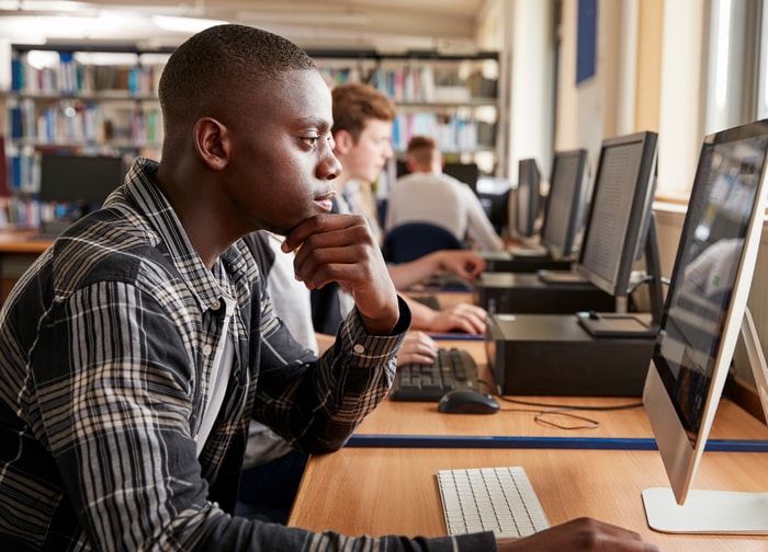 Male Student Working at the Library