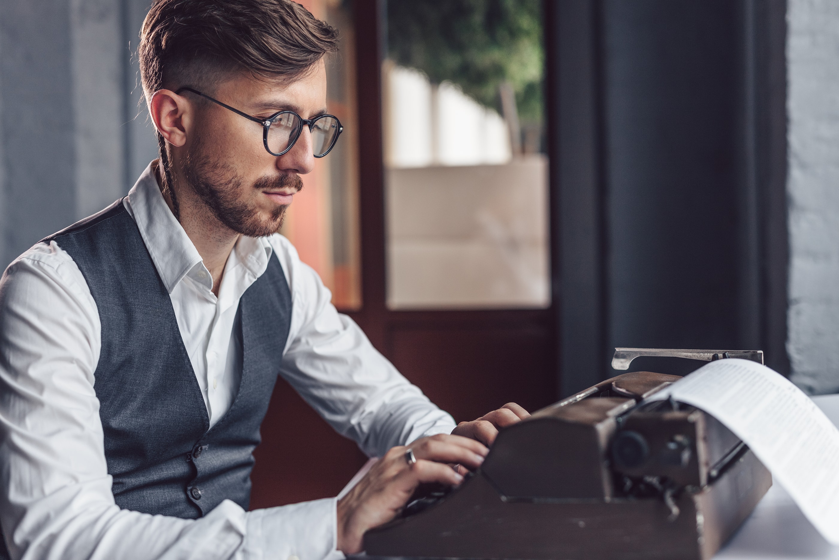 Man Typing on Typewriter