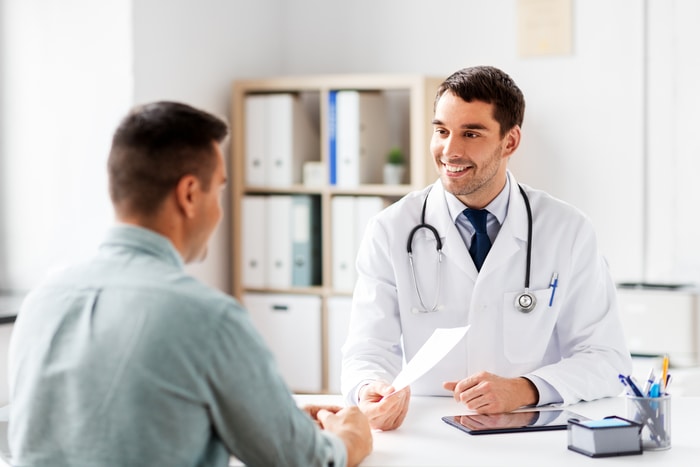 Doctor Giving Prescription to Patient