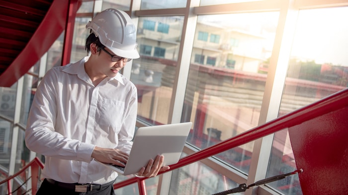 Male Engineer Working On Construction Costs