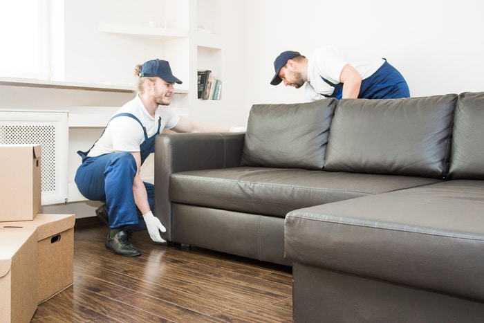 2 Males Moving Furniture in Apartment