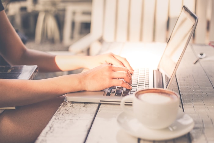 Woman Writing an Essay on a Computer